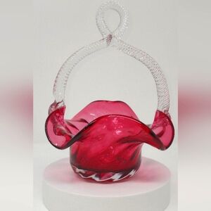 Vintage cranberry glass basket vase with looped clear glass handle. Height-9.5".